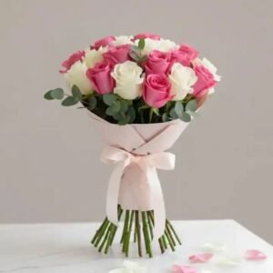 A hand-tied Pink & White Rose Bouquet wrapped in premium paper, perfect for anniversary or birthday gifts.